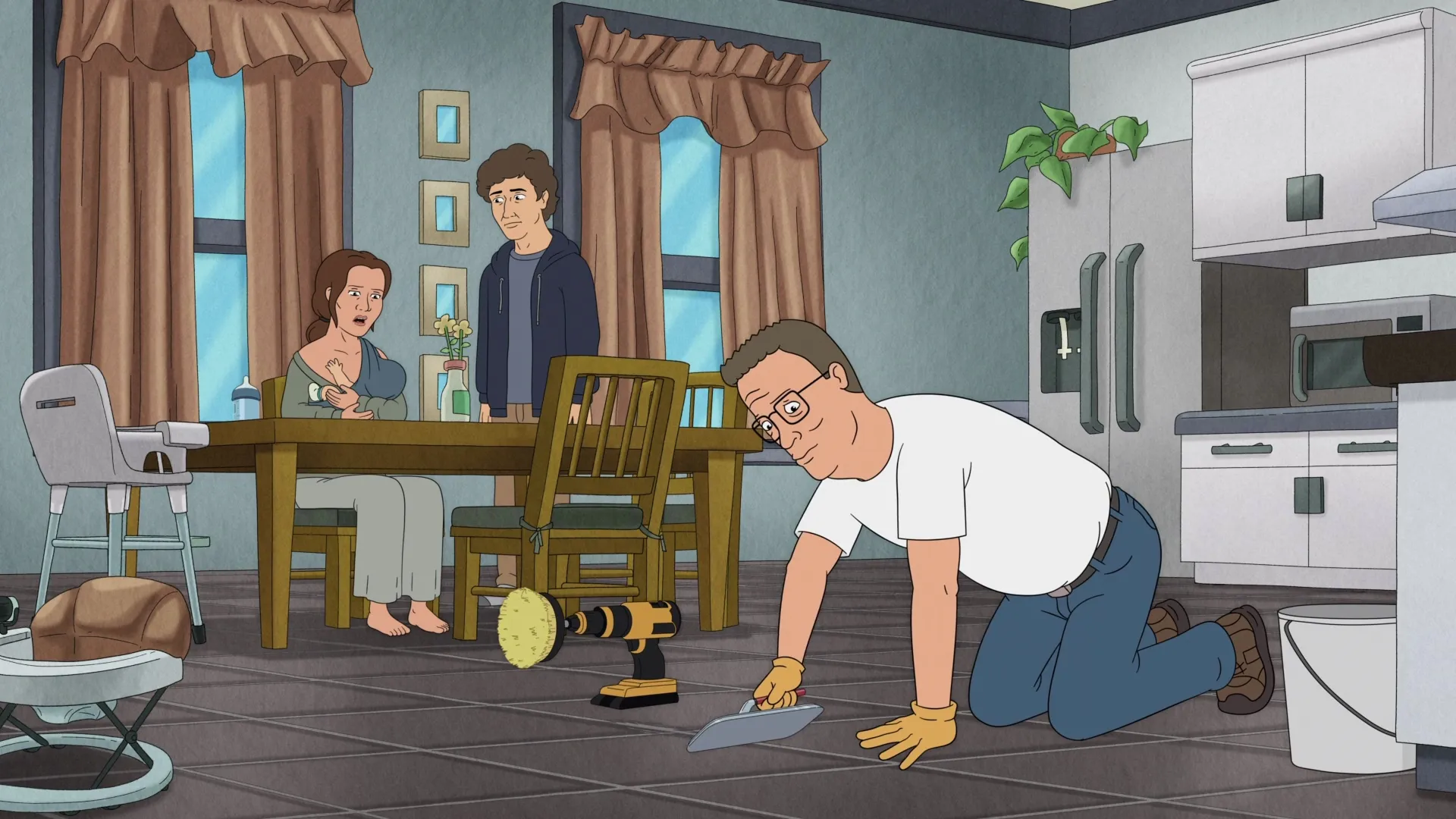 Hank (Mike Judge) kneels to repair a tiled kitchen floor while a couple and their baby watch.