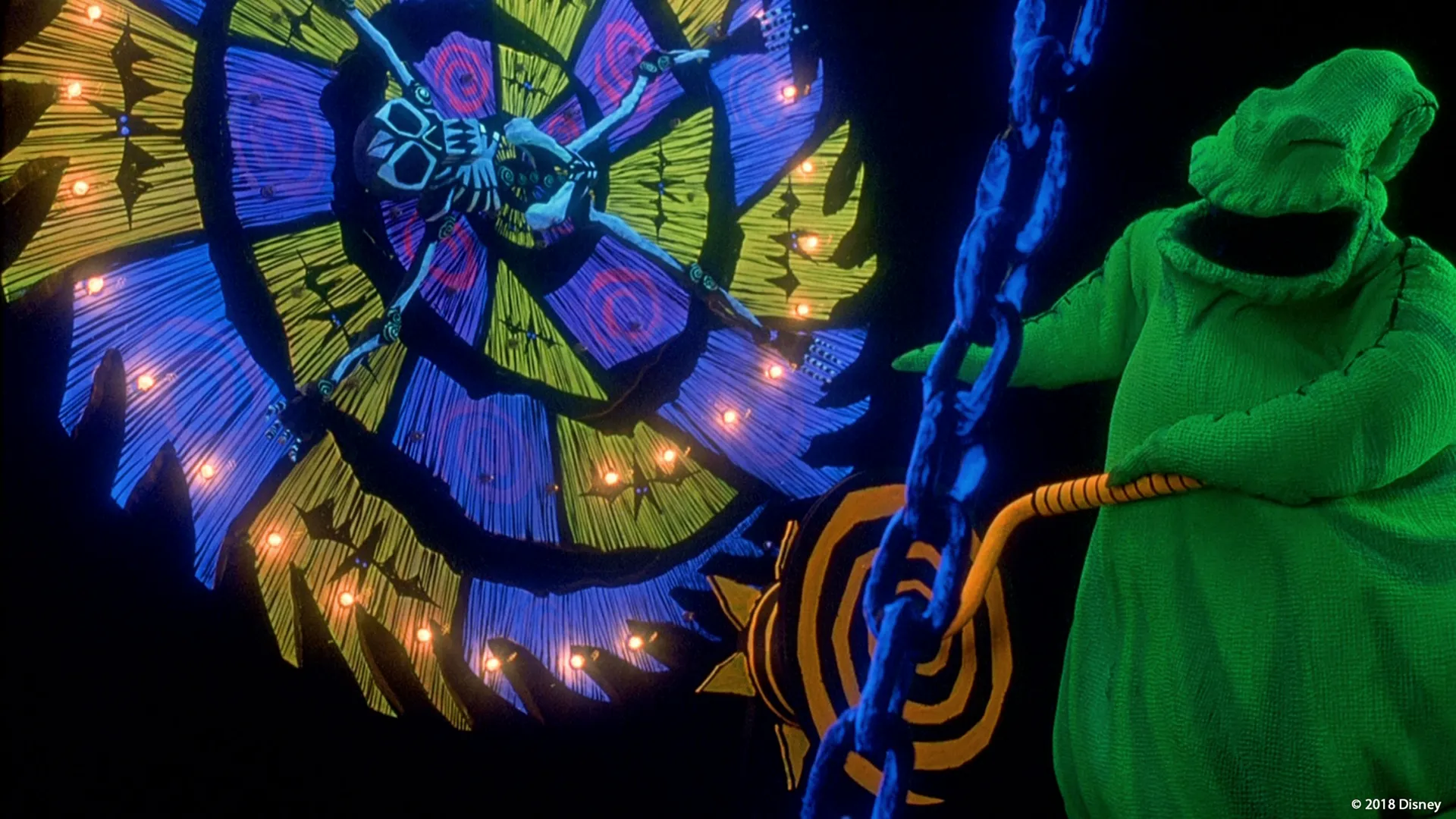 Oogie Boogie spins a wheel with a skeleton strapped to it.