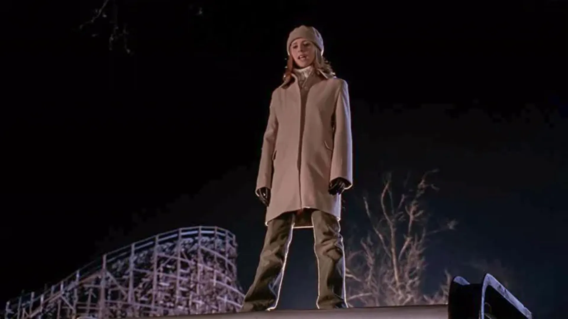 Buffy (Sarah Michelle Gellar) standing on a raised platform in winter clothes.