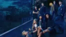 Coven Academy key art featuring the cast at the entrance to the school.