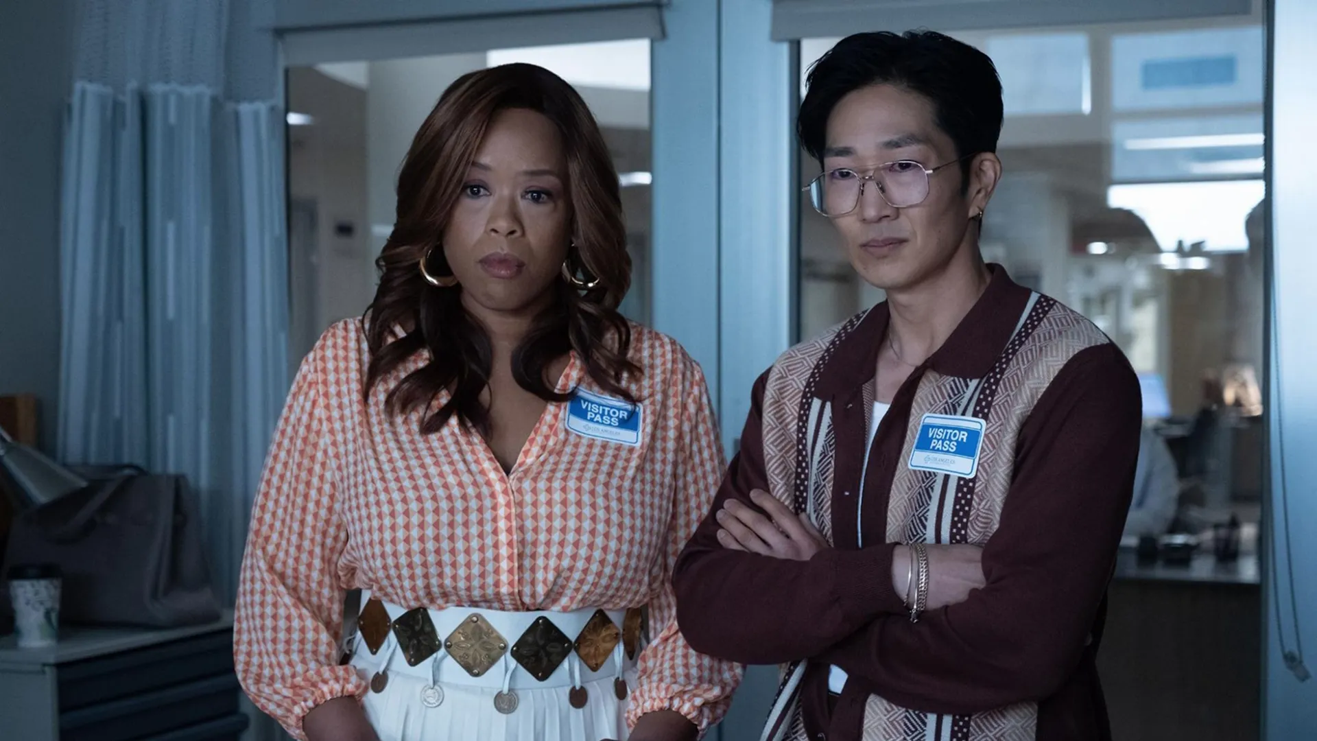 Reasonable Doubt characters Krystal (Angela Grovey) and Daniel (Tim Jo) stand by a hospital bedside