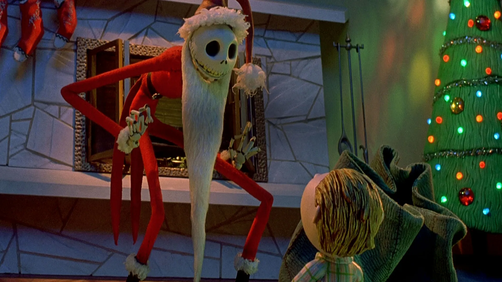 Jack Skellington, dressed as Santa Claus, looms over a child in a living room.