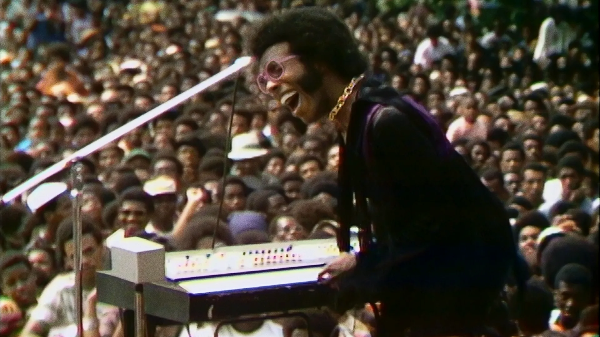  Sly Stone performing on stage with Sly and the Family Stone at the historic Harlem Cultural Festival in Mount Morris Park (now Marcus Garvey Park) in the summer of 1969