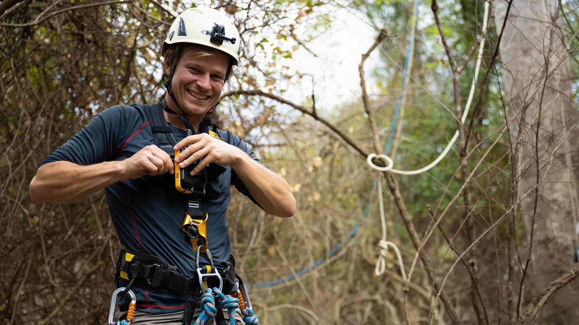 The image shows National Geographic filmmaker and explorer Bertie Gregory as he prepares for a canopy camp while filming the "Elephant Quest" episode of Animals Up Close with Bertie Gregory. 