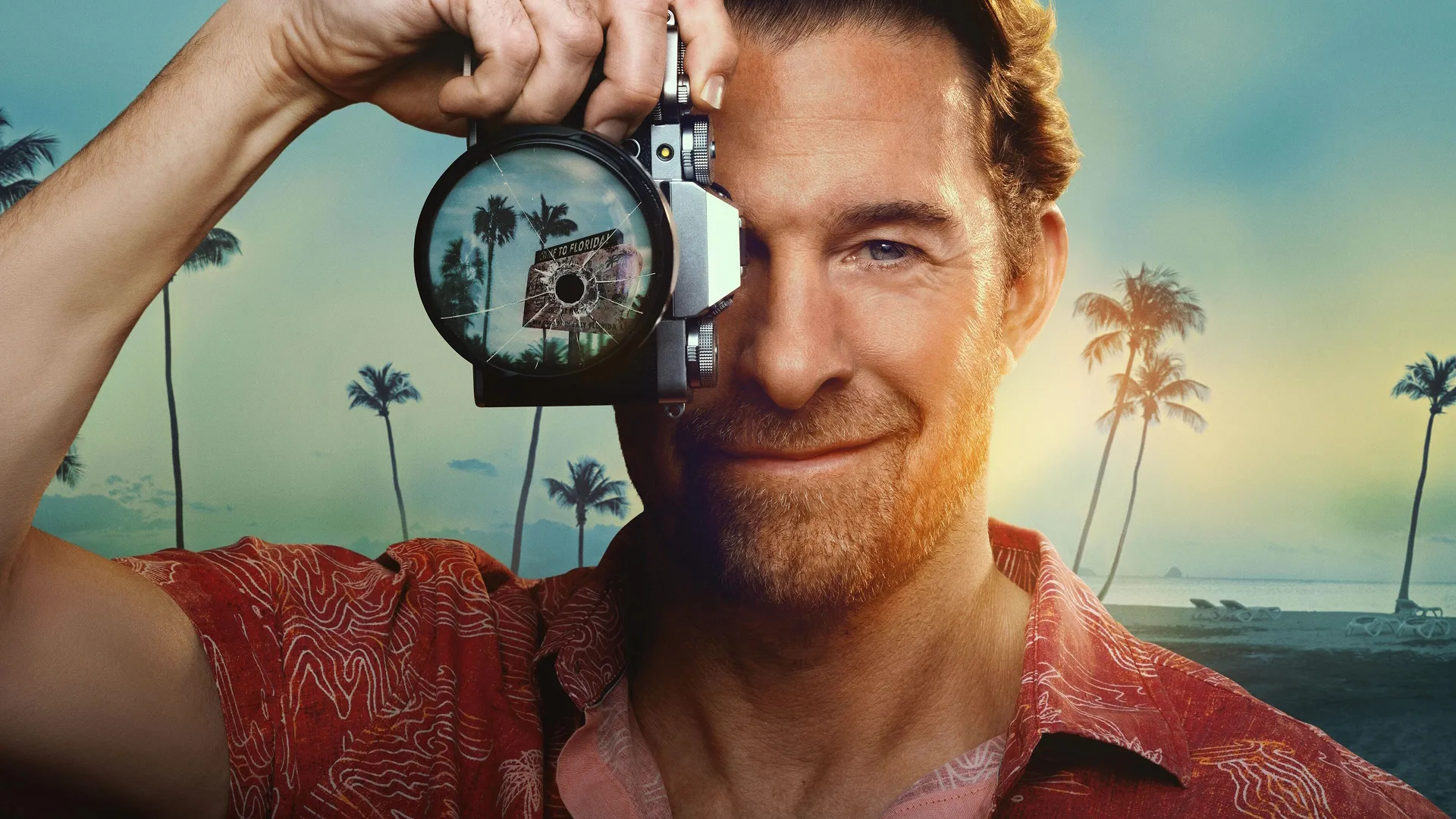 Scott Speedman as RJ Decker holding a camera and wearing a red Hawaiian shirt in a promotional image for the new ABC show.