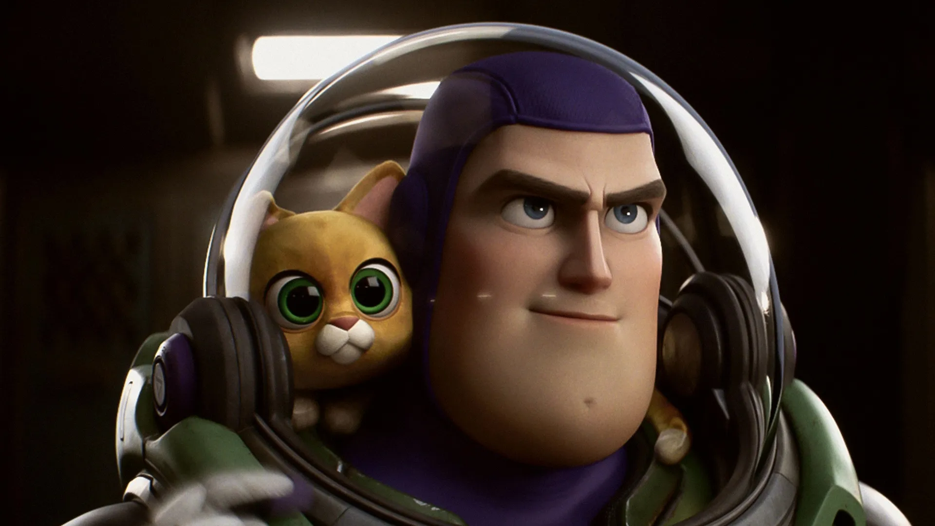 The space ranger Buzz Lightyear looks forward with a confident expression while wearing a transparent glass helmet, inside of which a small, wide-eyed orange robotic cat peeks over his shoulder, in a close-up still from the animated movie Lightyear.