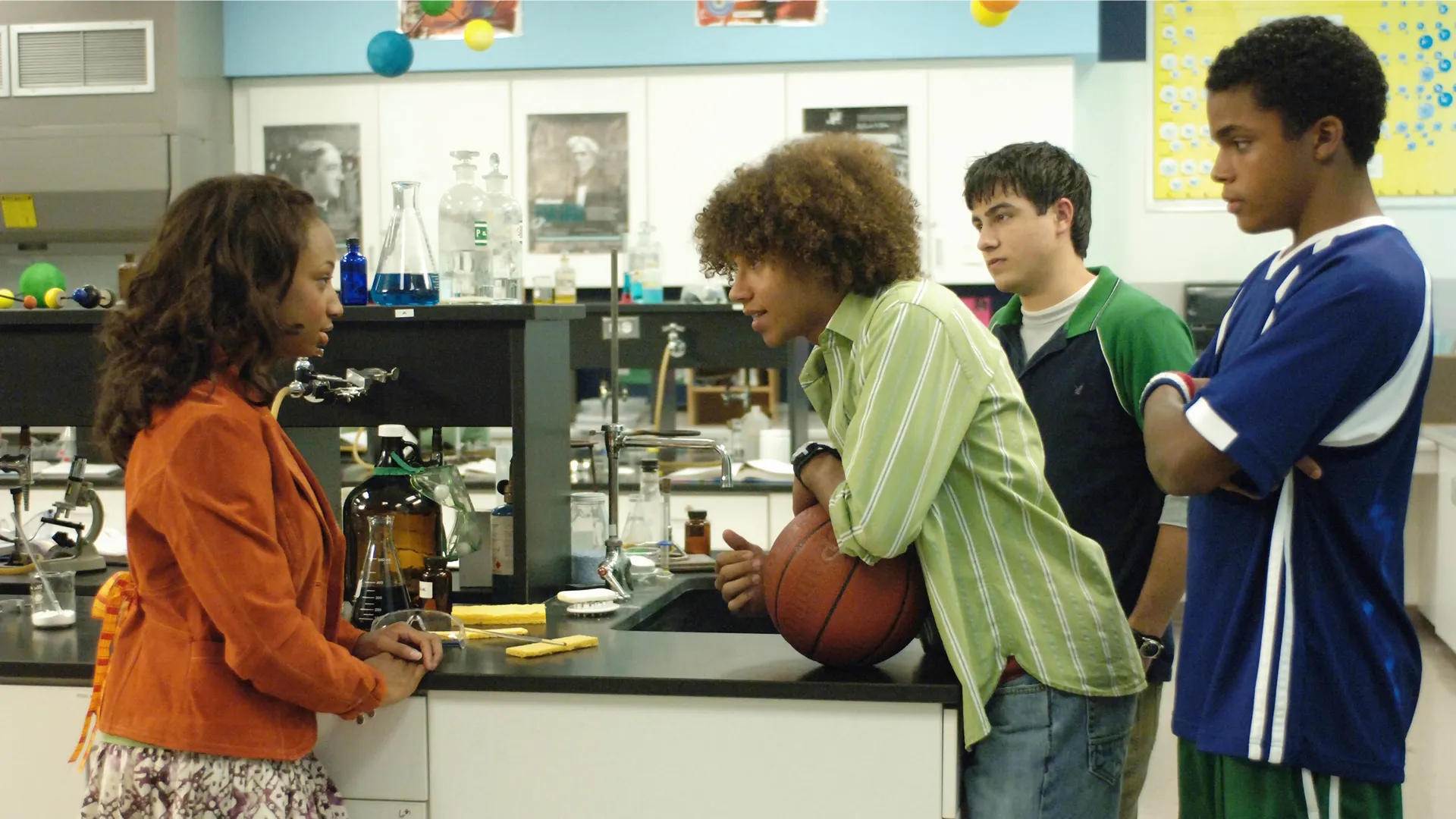 Chad (Corbin Bleu) talks to Taylor (Monique Coleman) in a school laboratory