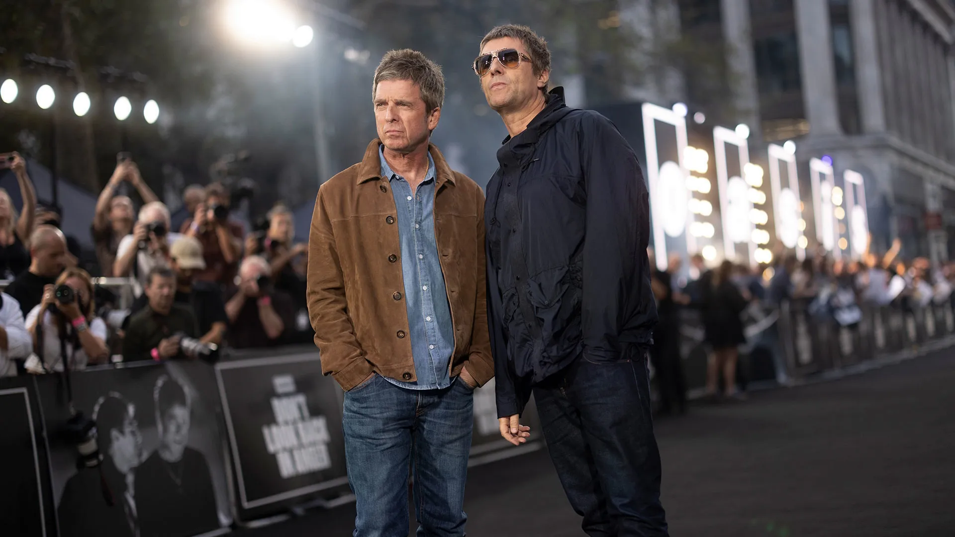 Noel Gallagher and Liam Gallagher pose on the red carpet at the London premiere of Oasis: Don’t Look Back in Anger.