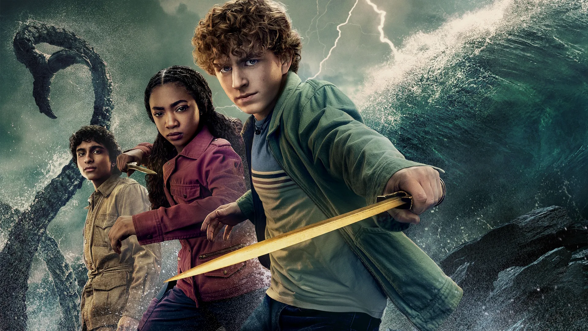 Grover (Aryan Simhadri), Annabeth (Leah Sava Jeffries) and Percy Jackson (Walker Scobell). Crashing stormy waves and a sea monster tentacle in the background.