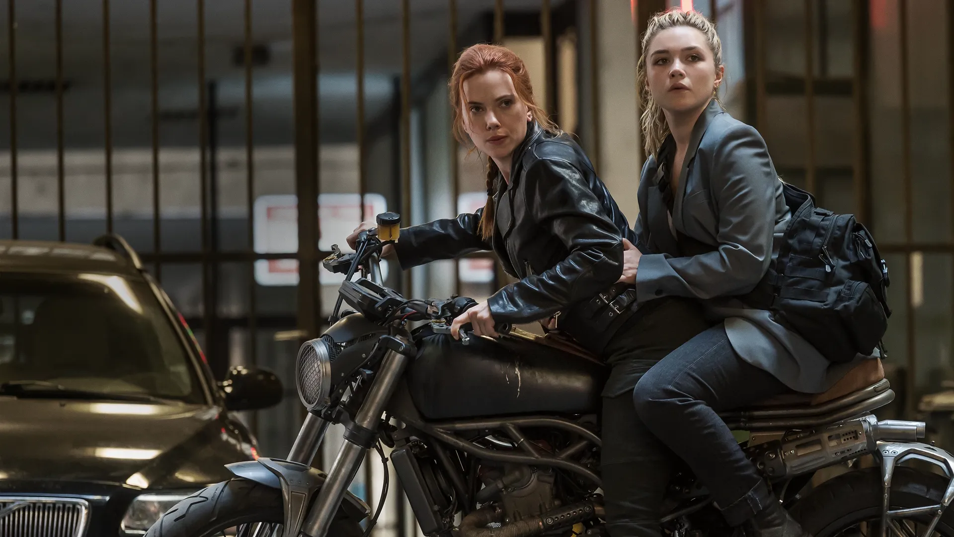 This image shows a scene from the 2021 Marvel Studios film Black Widow featuring Natasha Romanoff (Scarlett Johansson) and Yelena Belova (Florence Pugh). 
