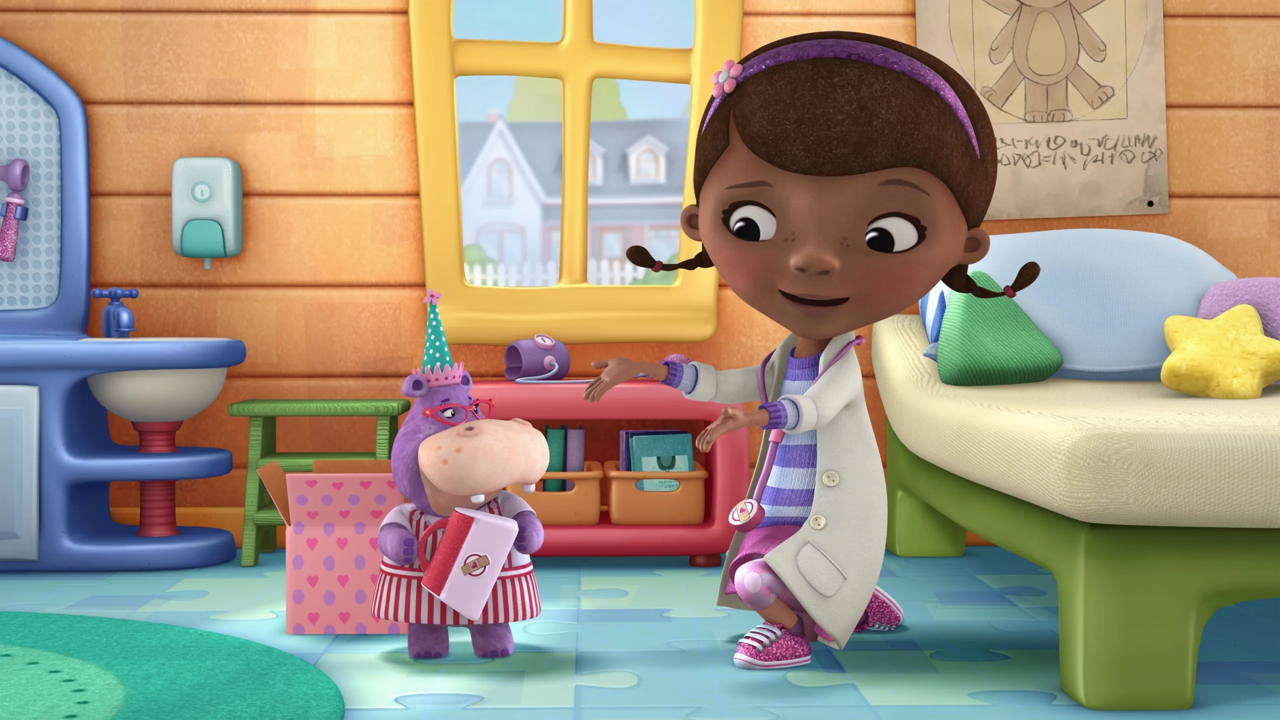 Doc McStuffins is in her examination room talking to a small hippo wearing a party hat