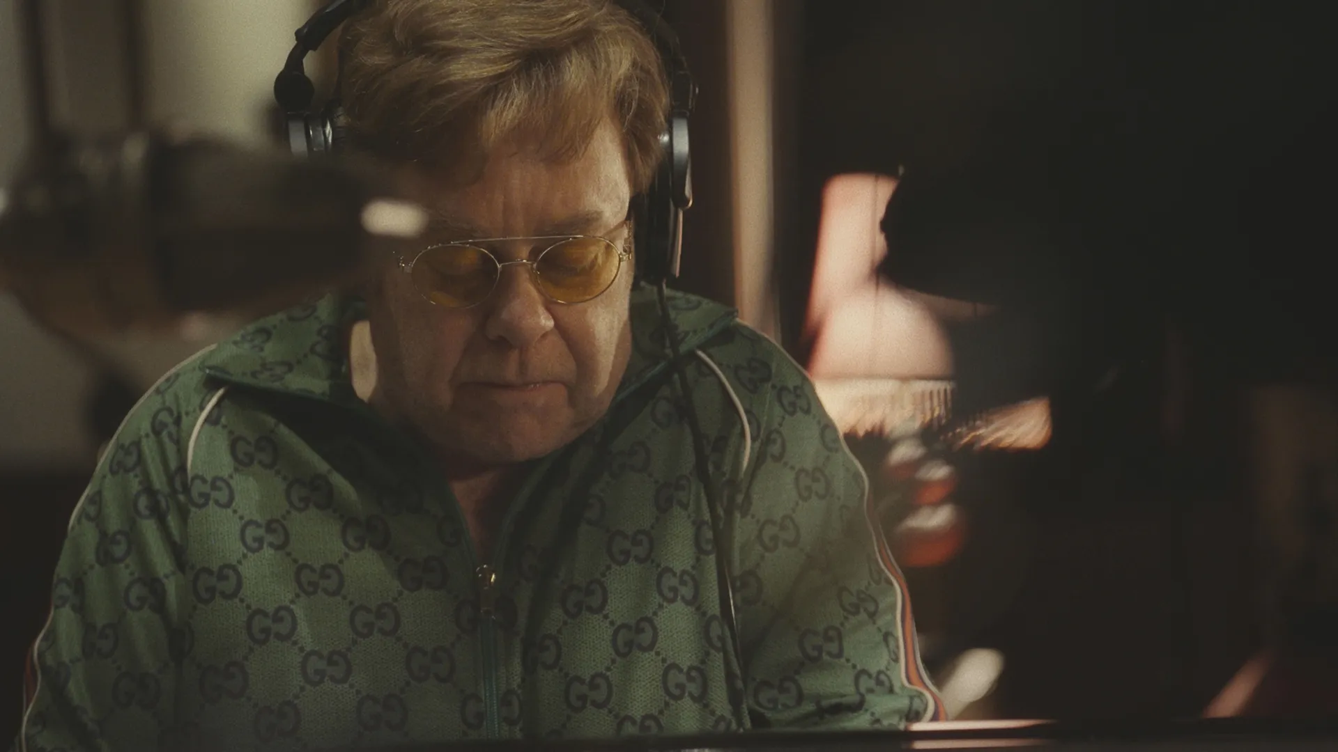 Elton John in a recording booth.
