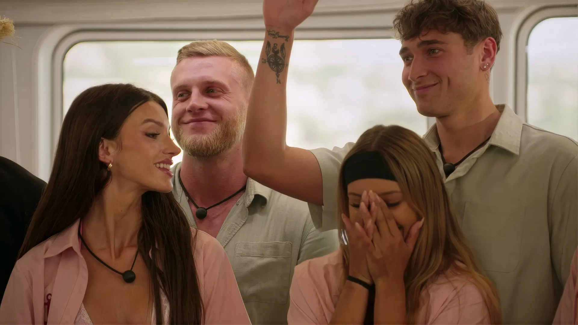 A group of contestants react to some news on Love Overboard