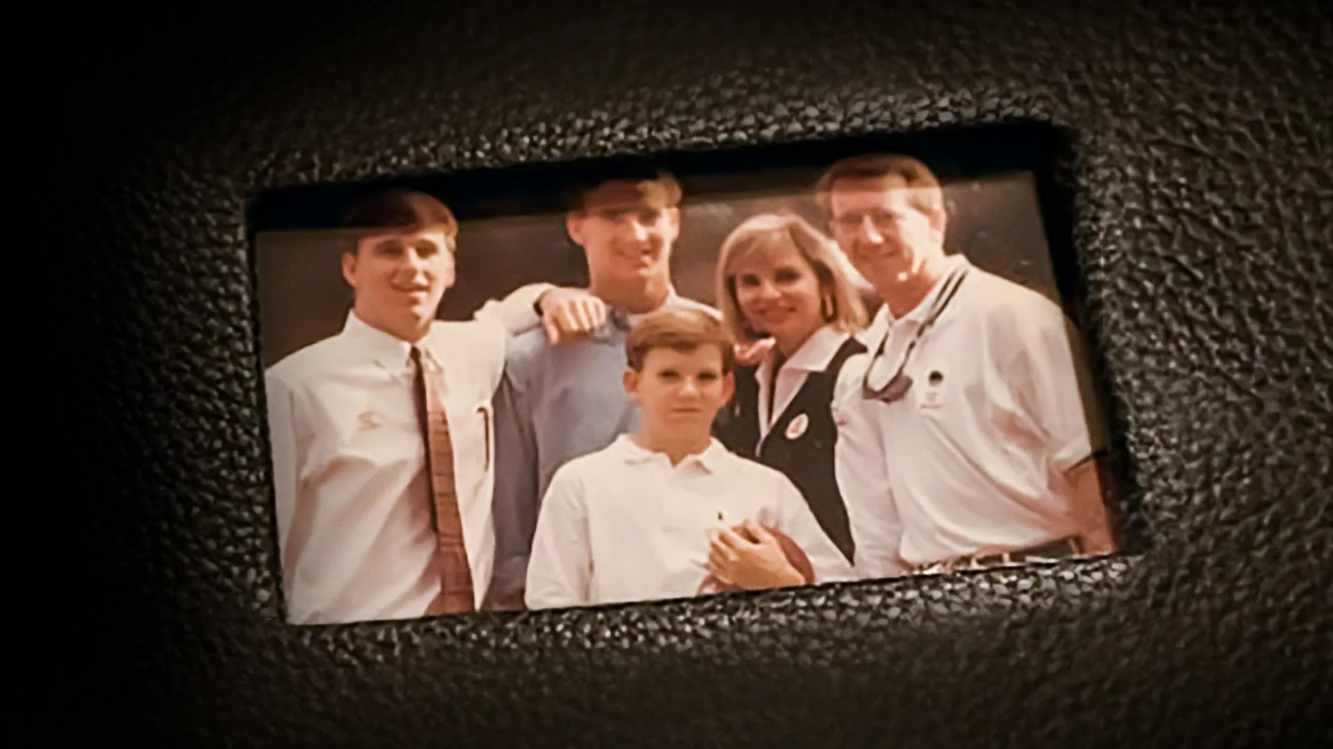 This image features the Manning family, a prominent sports family, captured in a portrait from the early 1990s.