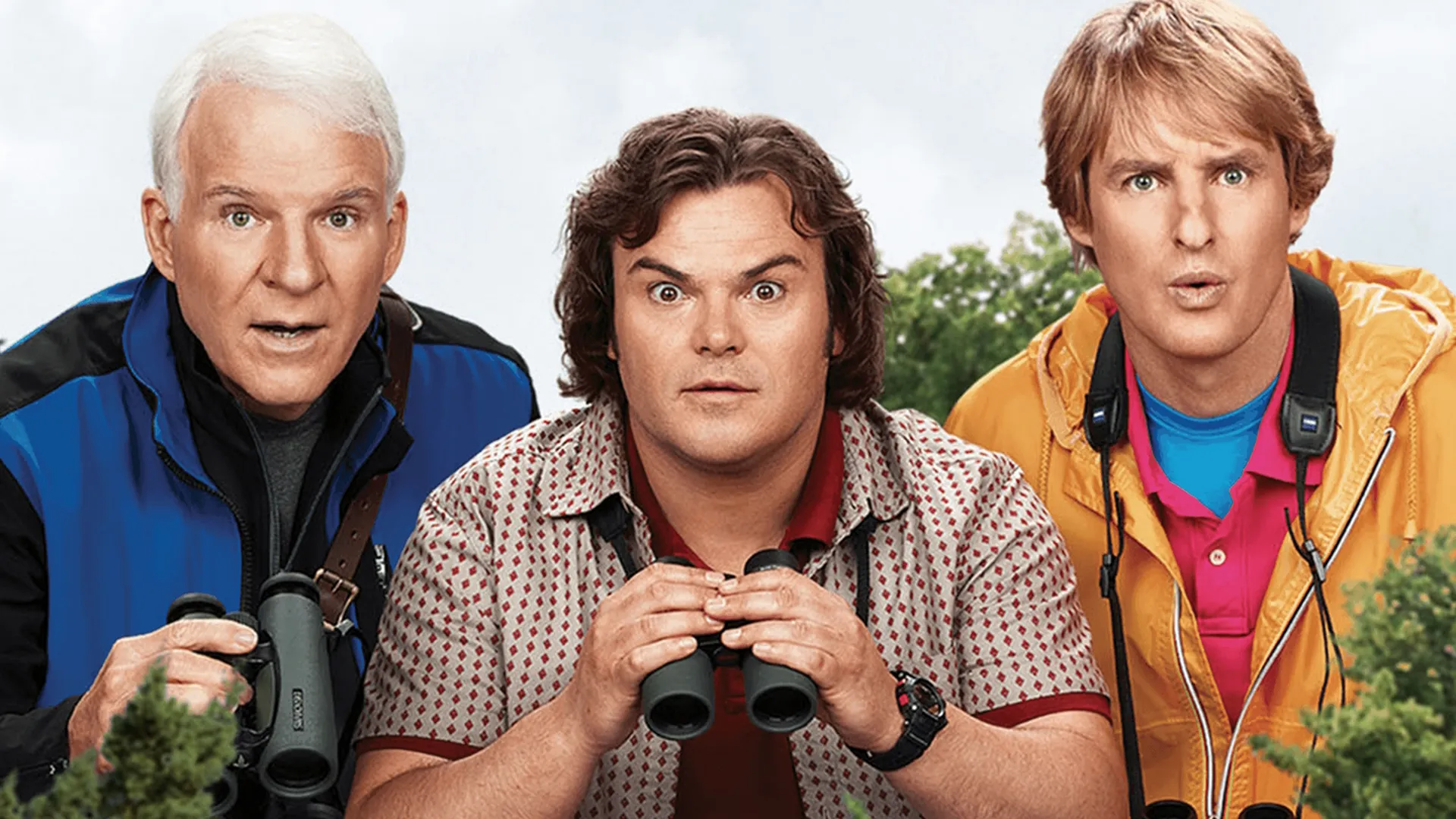 Stu Preissler (Steve Martin,) Brad Harris (Jack Black,) and Kenny Bostick (Owen Wilson) birdwatching from a hedge with binoculars in The Big Year.