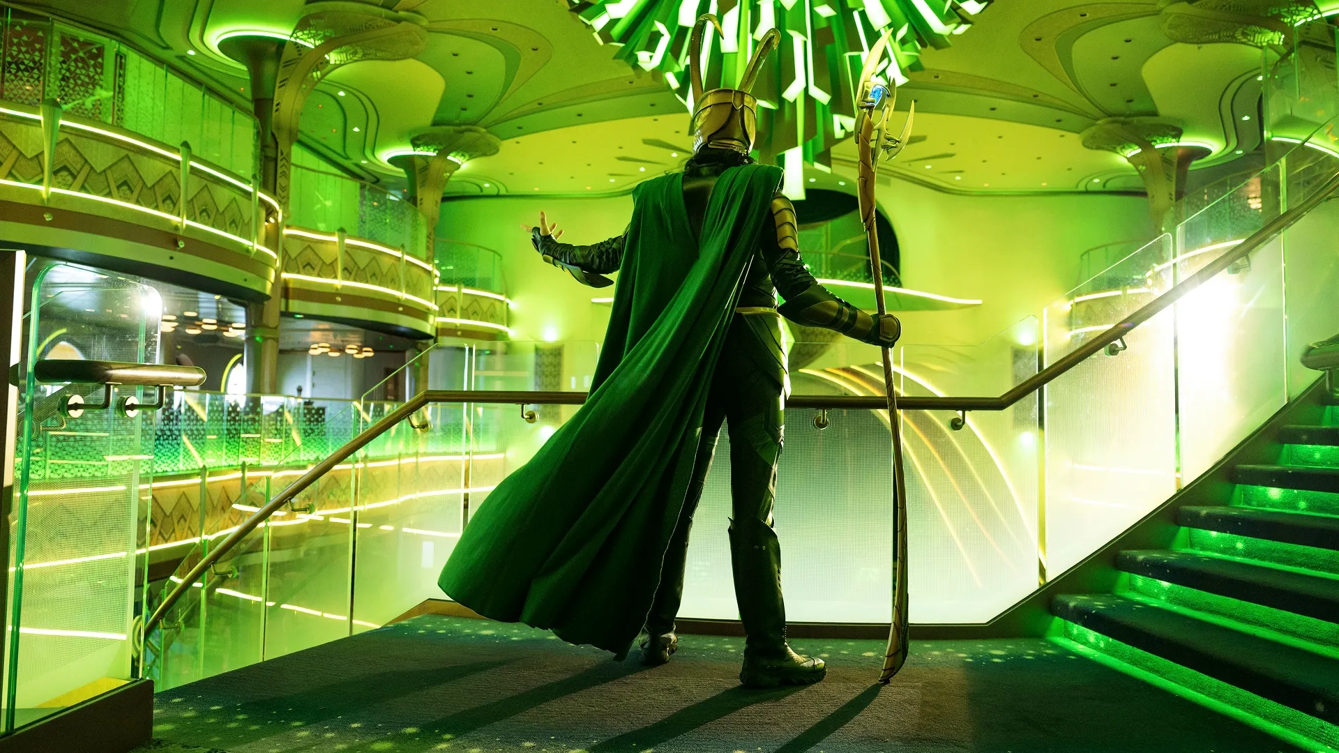 The image captures Loki during "The Legend of Loki" interactive live show experience in the Grand Hall aboard the Disney Cruise Line ship, the Disney Destiny