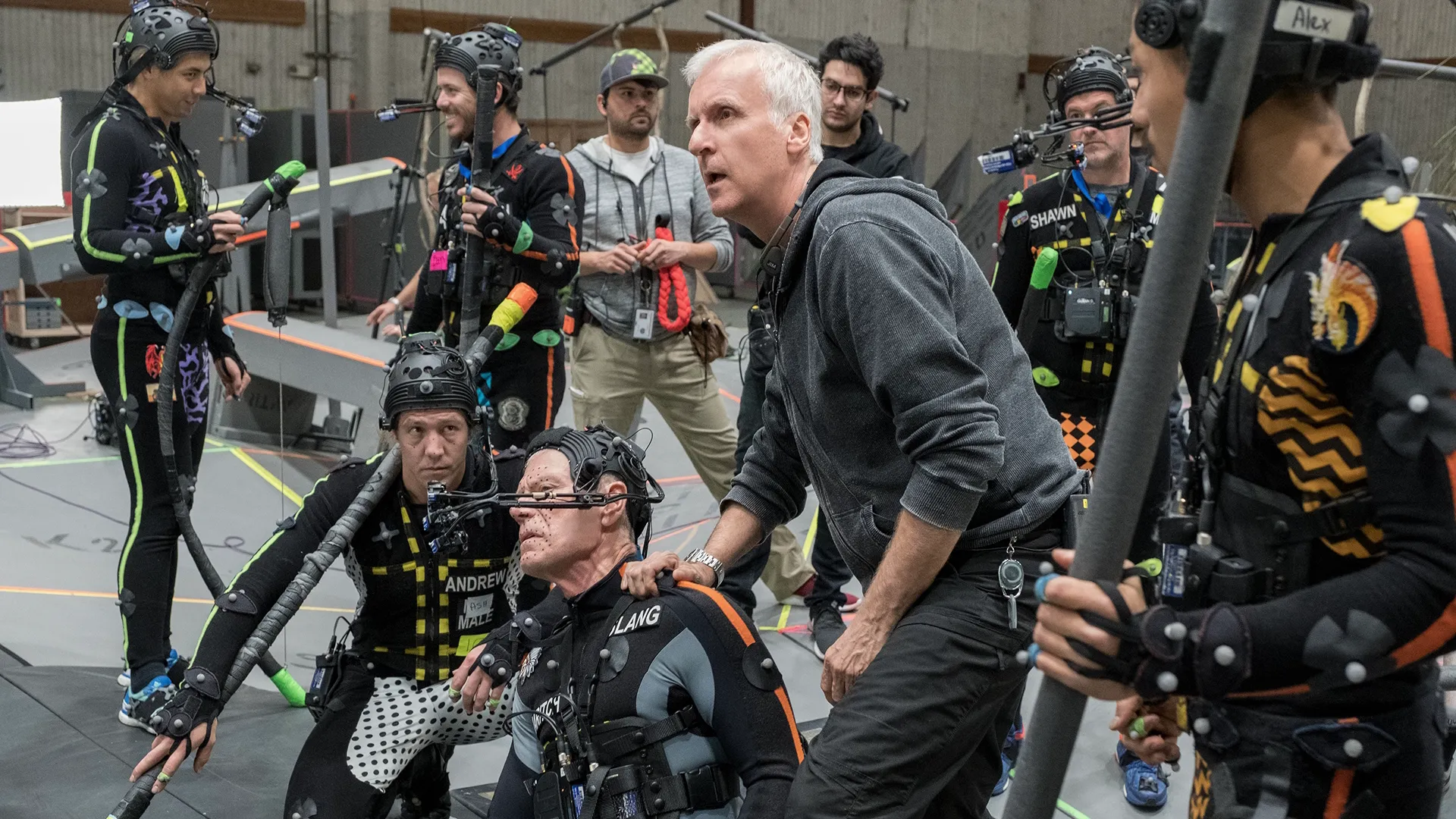 Director James Cameron and various actors in motion capture costumes on the set of Avatar: Fire and Ash.