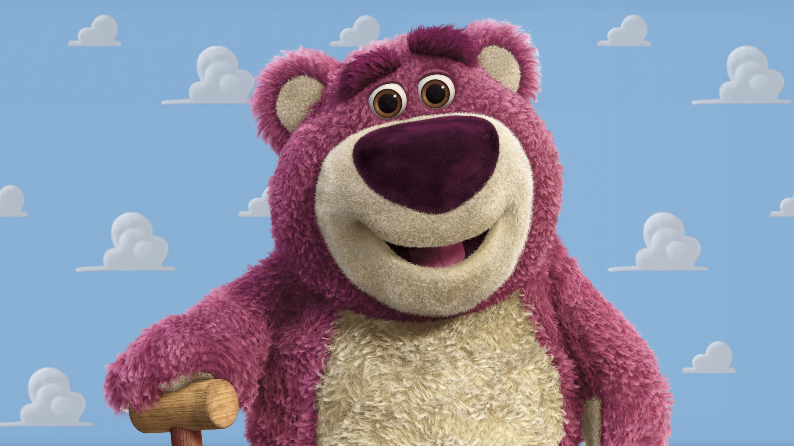 A purple stuffed bear with a cane