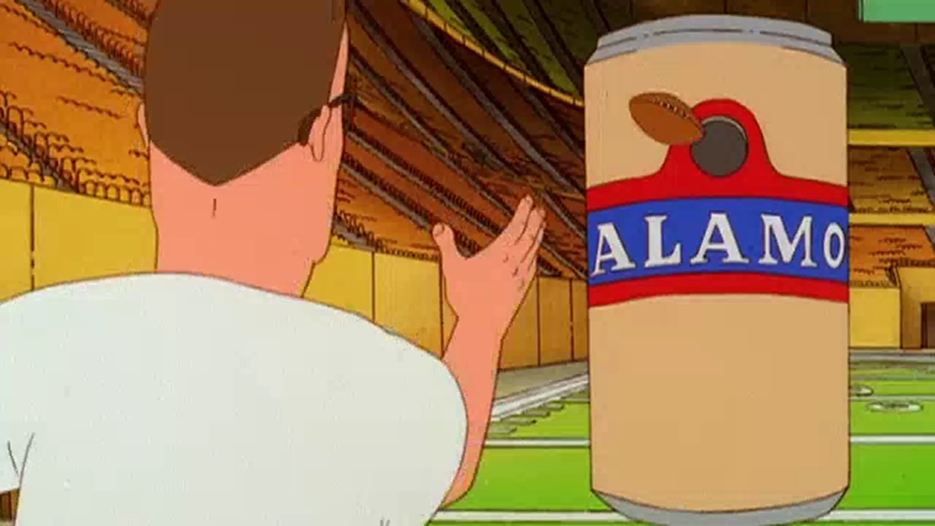 Hank (Mike Judge) throws a football towards an enormous Alamo beer can.