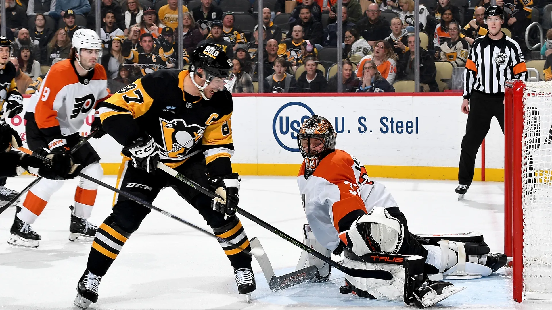 Players from the Pittsburgh Penguins and Philadelphia Flyers during an NHL match.