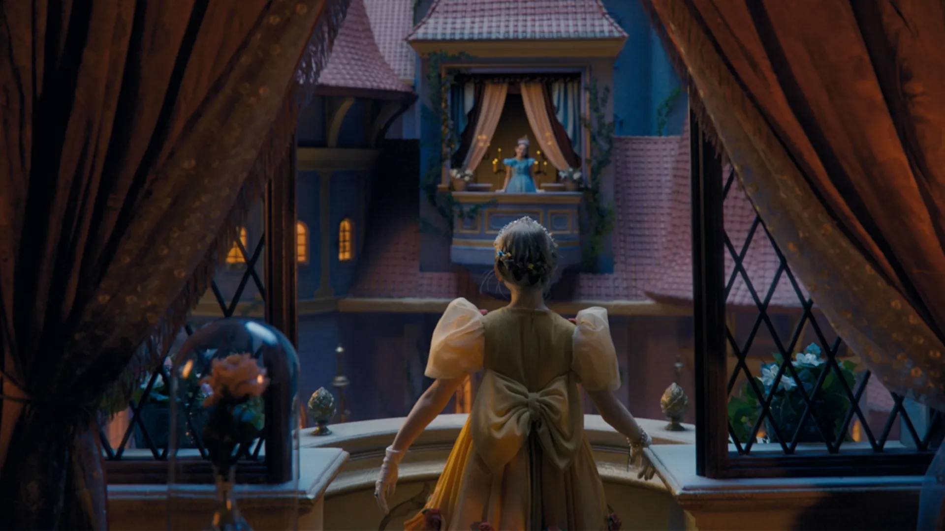 Two girls dressed as Disney Princesses look across to each other from opposing rooms in a castle.