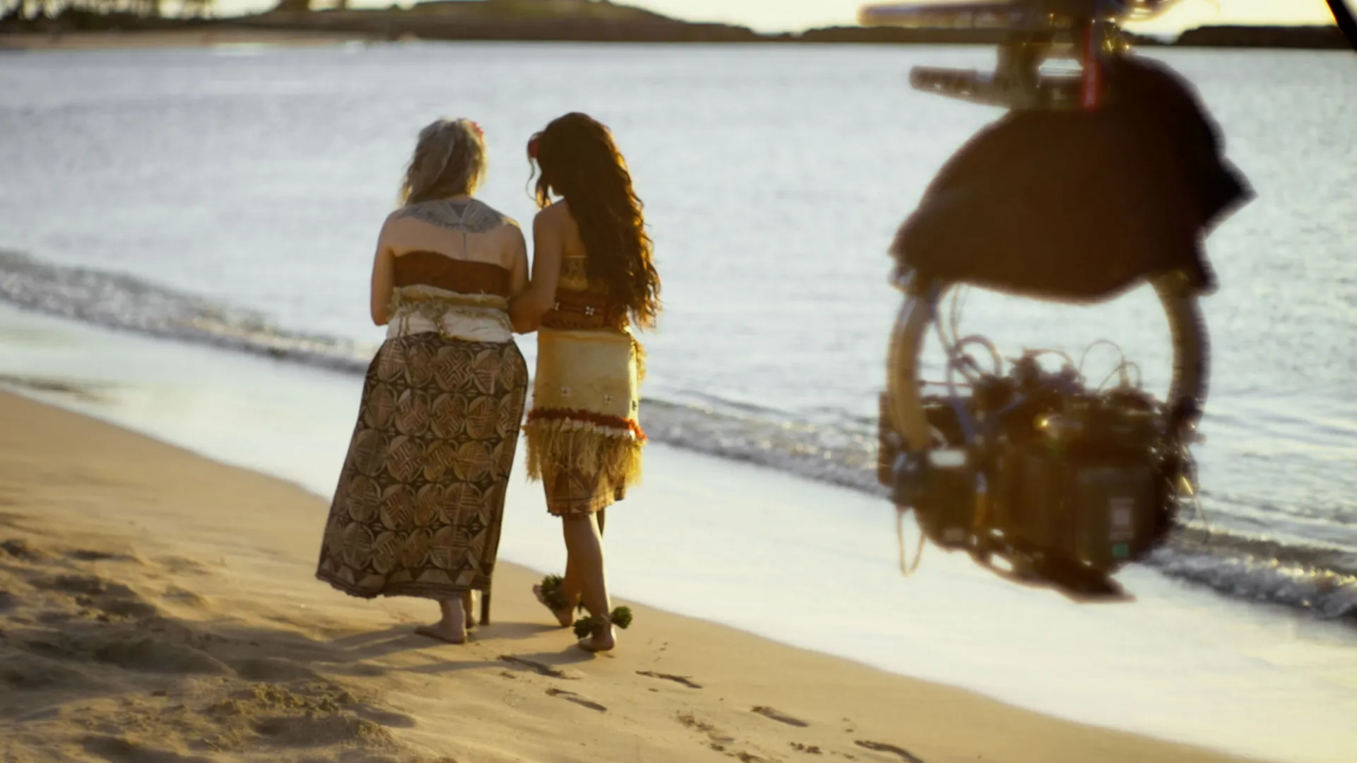 Behind the scenes shot showing Moana walking along the beachfront with her grandma.