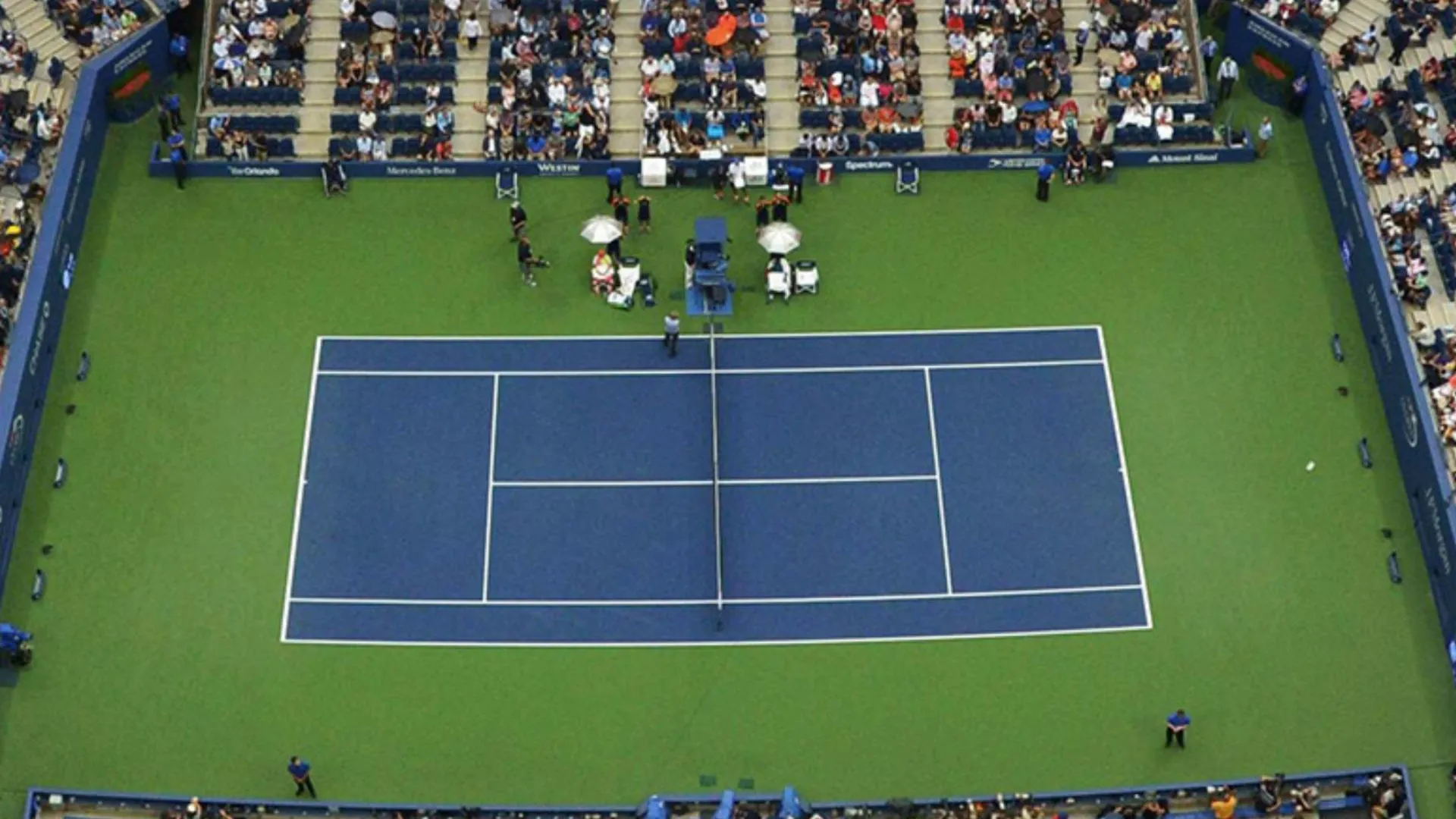 This image shows a high-angle view of the tennis court at the Arthur Ashe Stadium, which is the main venue for the U.S. Open.