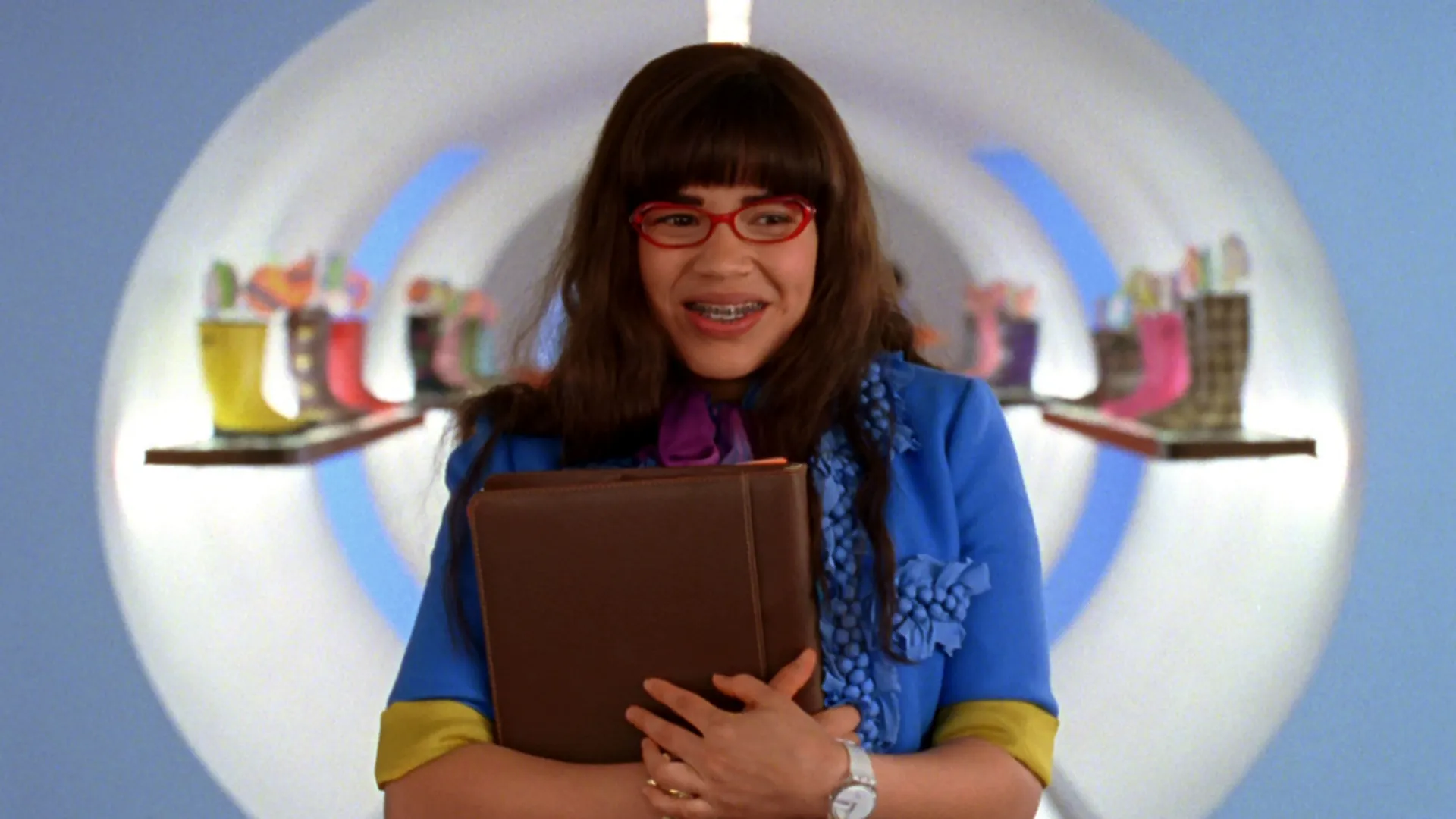 Betty Suarez (America Ferra) walks through the hallway of the MODE offices in Ugly Betty.