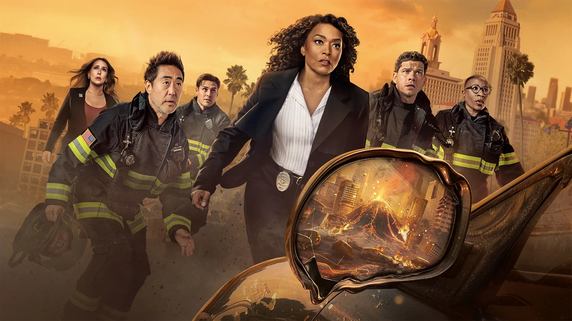 9-1-1 Season 10 promotional art featuring the main cast lead by Athena Grant (Angela Bassey) facing an erupting volcano reflected in a car's melting wing mirror.