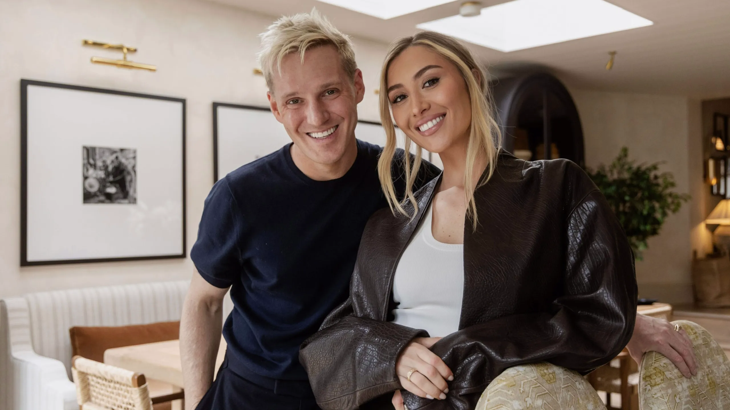 Jamie Laing and Sophie Habboo standing together in a living room.