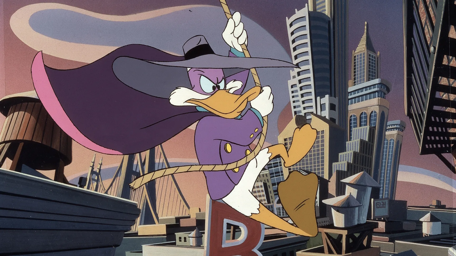 The image features Darkwing Duck, the titular caped crimefighter from the classic 1991 Disney animated television series. He is shown swinging from a rope in front of his home city's skyline, St. Canard.