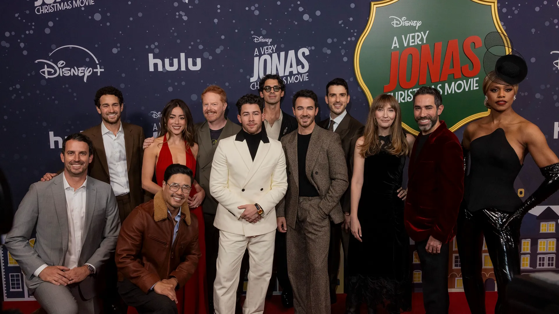 Cast of A Very Jonas Christmas in a group photo at the Red Carpet premiere in New York (L-R: Scott Morgan, Spencer Berman, Randall Park, Chloe Bennet, Jesse Tyler Ferguson, Nick Jonas, Joe Jonas, Kevin Jonas, Isacc Aptaker, Elizabeth Berger, Adam Fishbach, Laverne Cox)