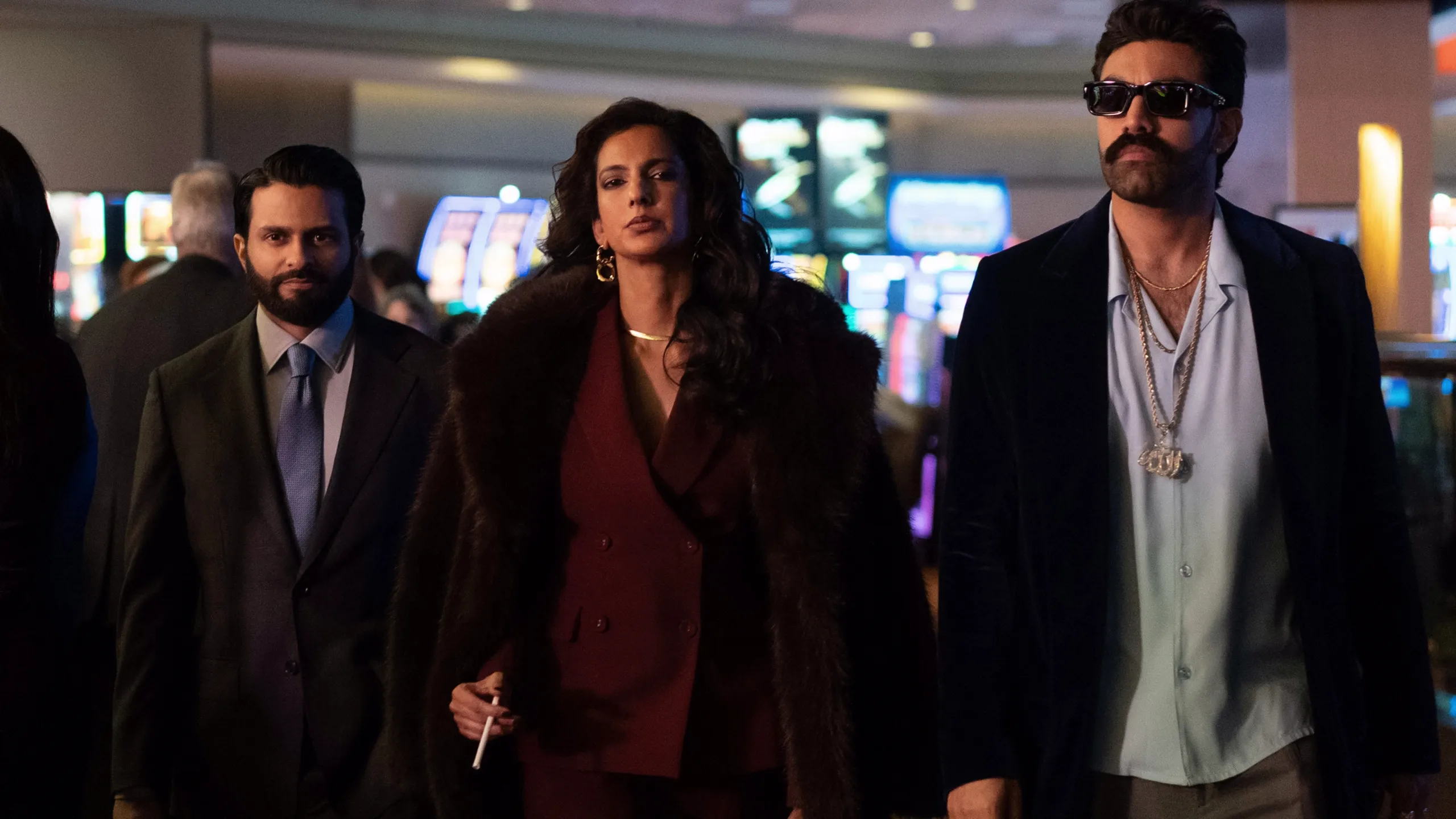 The Dars walk through a casino in the second season of Deli Boys.