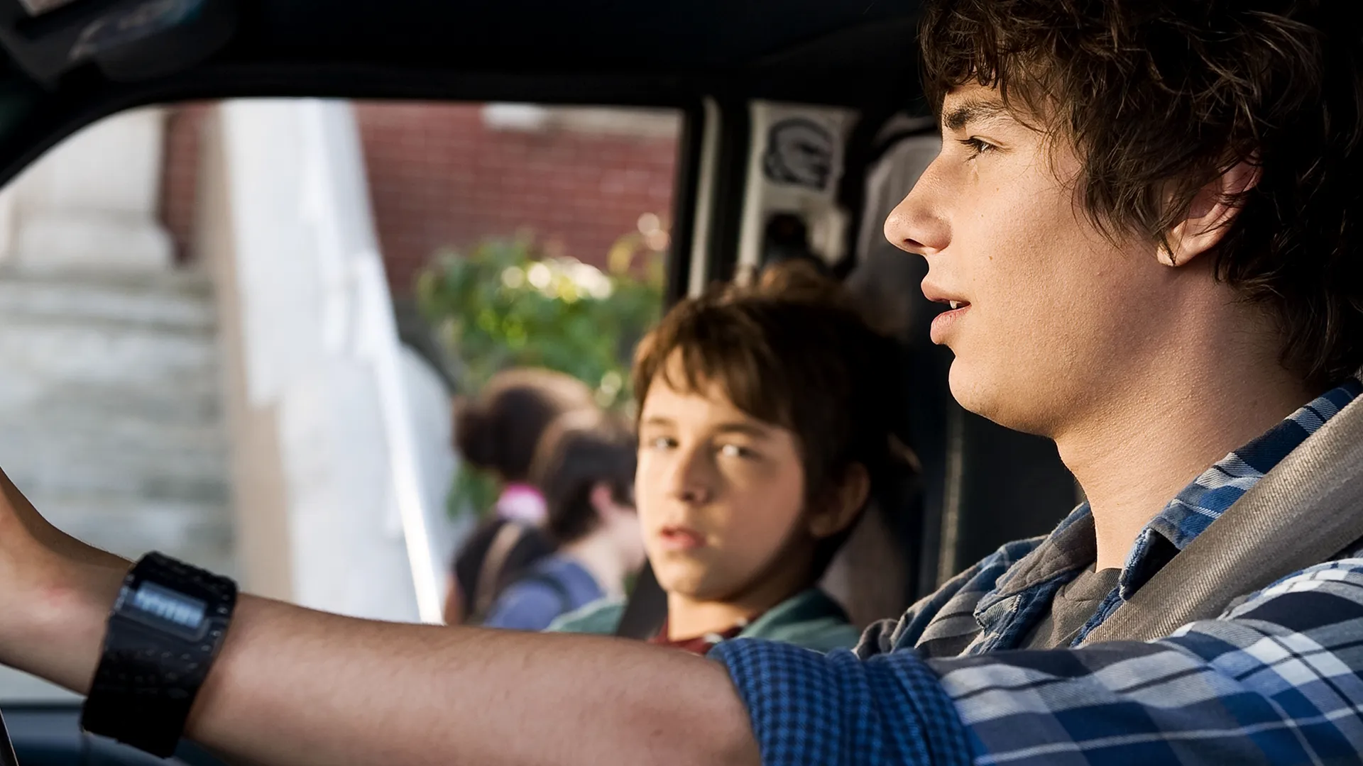 Greg Heffley (Zachary Gordon) as the passenger in his older brother Rodrick's (Devon Bostick) car.