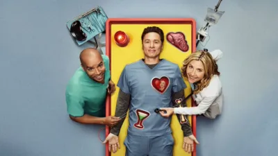 J.D. on a fake operating table with Elliot and Turk at his side.