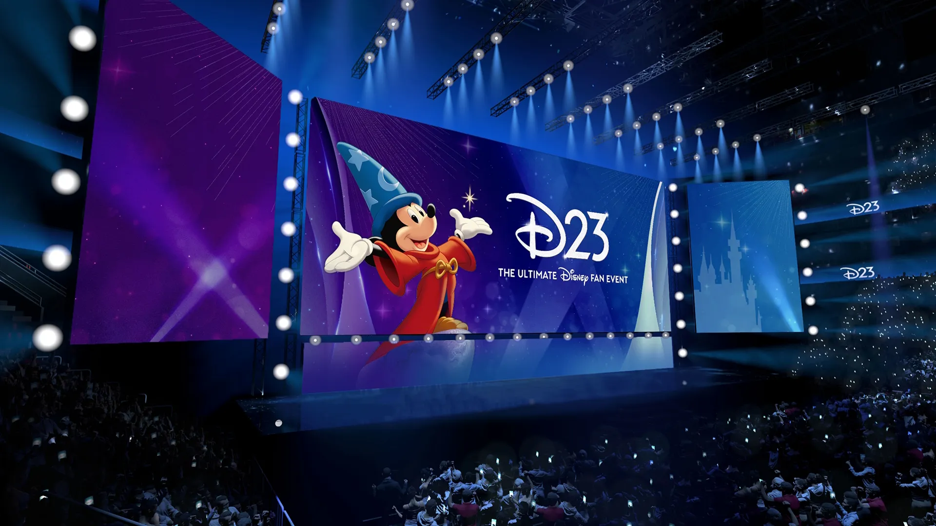 A large stadium stage features massive, vibrant purple and blue screens displaying the "D23: The Ultimate Disney Fan Event" logo alongside Sorcerer Mickey Mouse as a crowd watches from below.