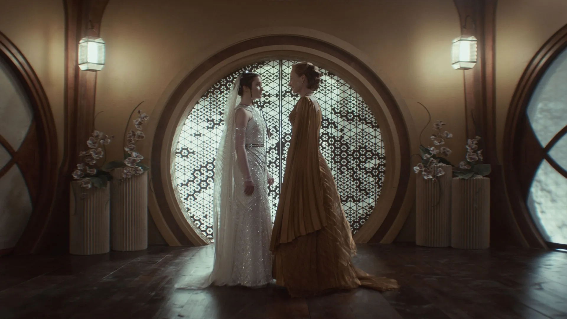 Mon Mothma (Genevive O'Reilly) with her daughter Leida (Bronte Carmichael) before the wedding ceremony in "Harvest" — both wearing costumes designed by Michael Wilkinson and his team.