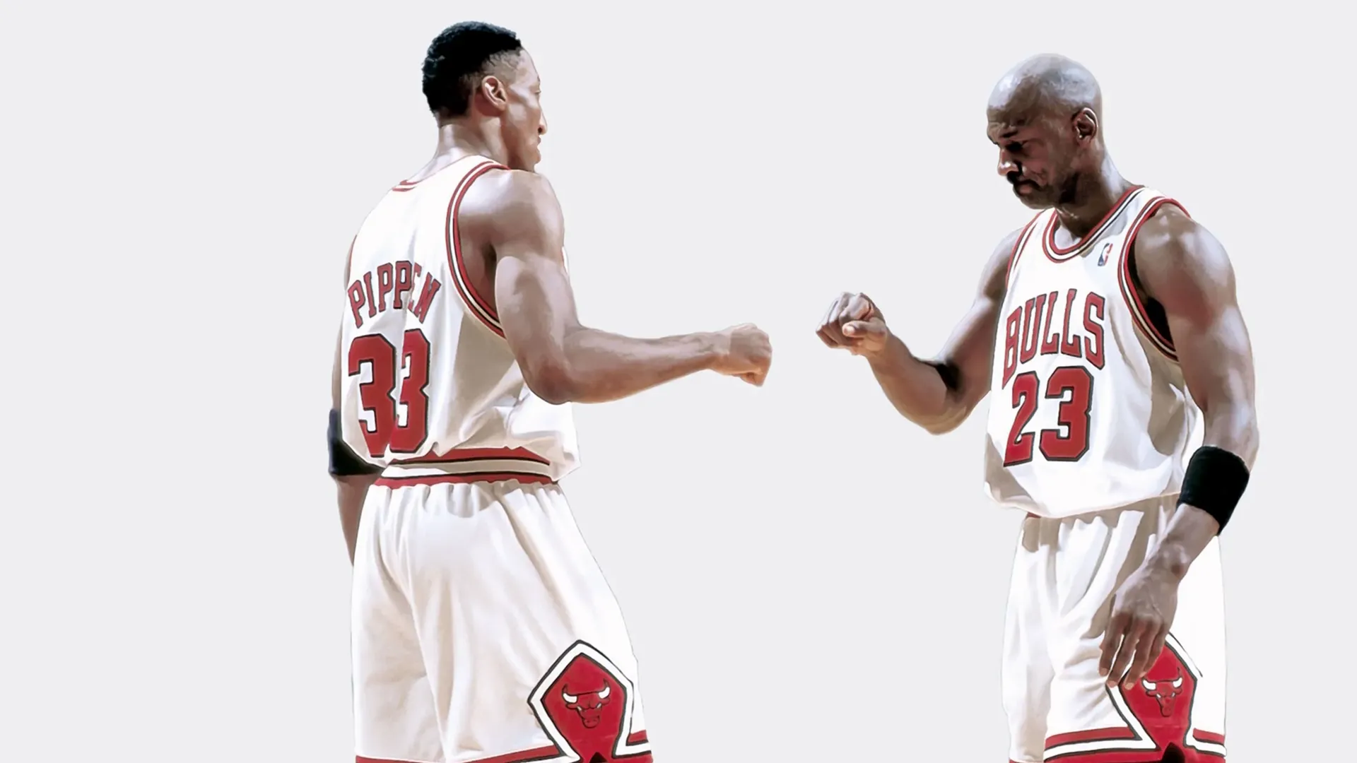 Michael Jordan and Scottie Pippen, both in their Chicago Bulls jerseys, share a fist bump.