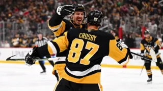Sidney Crosby, the captain and center for the Pittsburgh Penguins, celebrating a goal with teammate Rickard Rakell