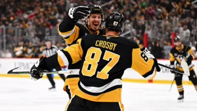 Sidney Crosby, the captain and center for the Pittsburgh Penguins, celebrating a goal with teammate Rickard Rakell