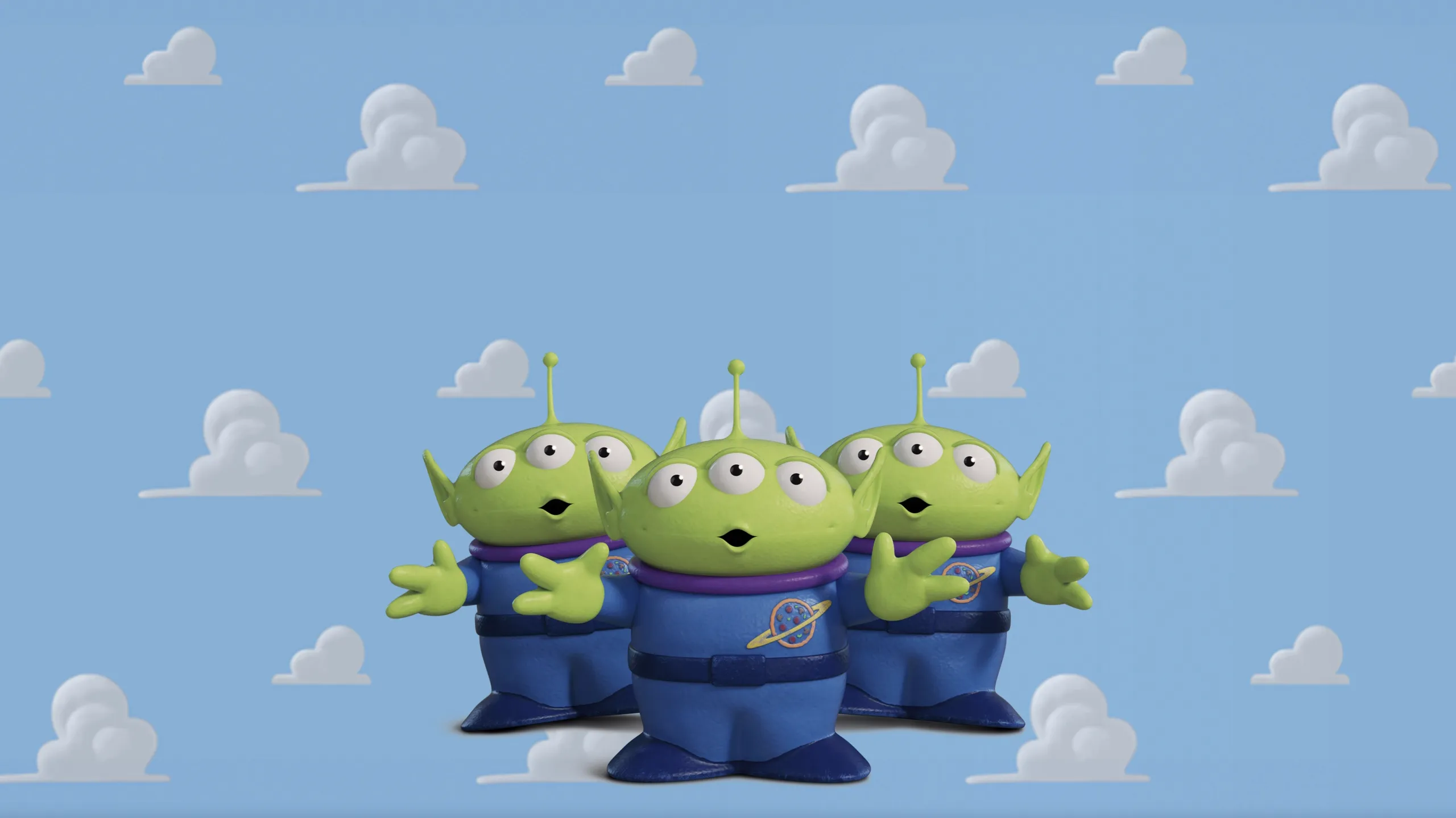 Three small, green, three-eyed alien characters with antennas on their heads