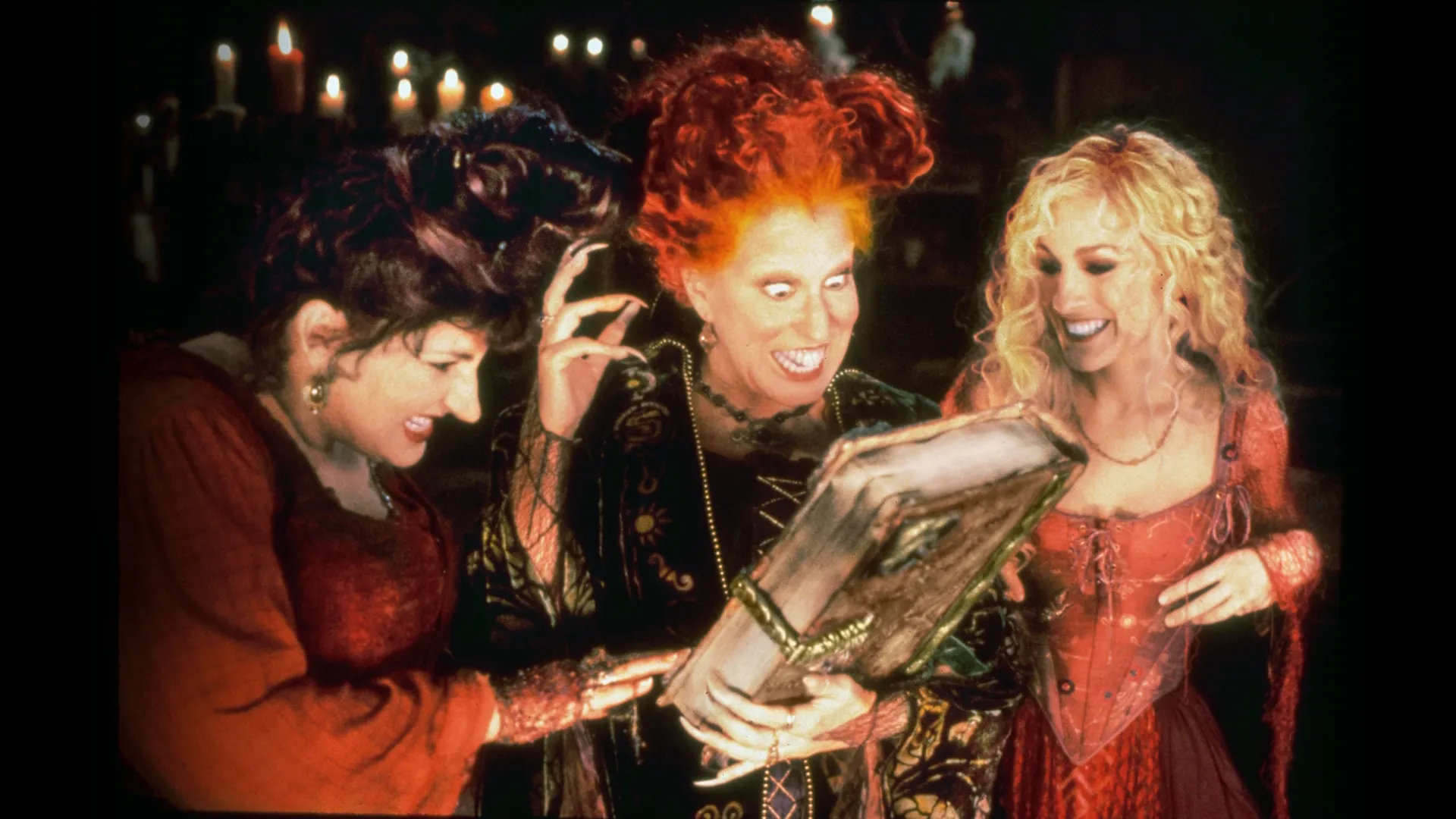 The Sanderson sisters with their spell book in the original Hocus Pocus movie.
