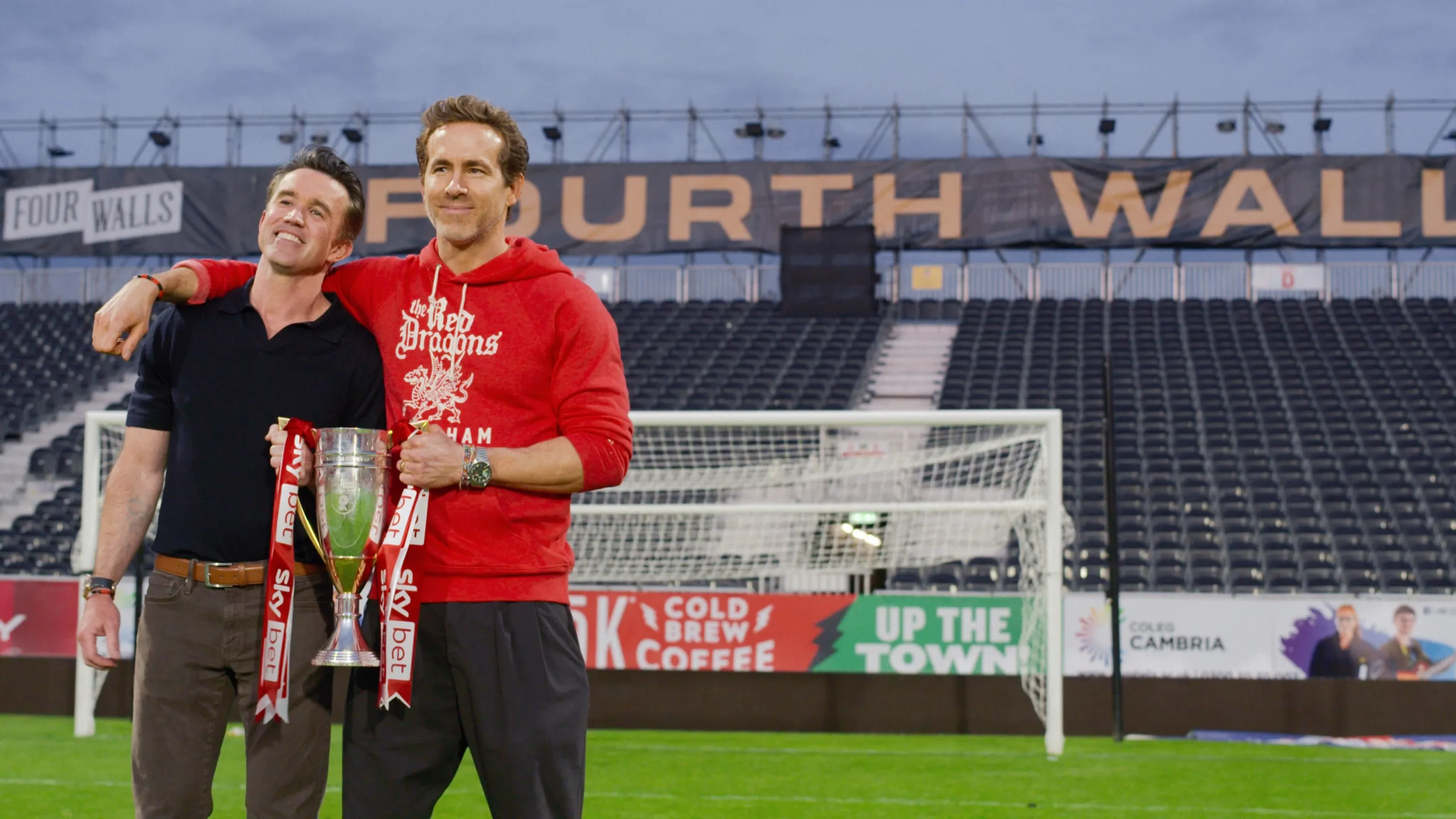 Rob Mac and Ryan Reynolds holding a trophy