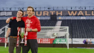 Rob Mac and Ryan Reynolds holding a trophy