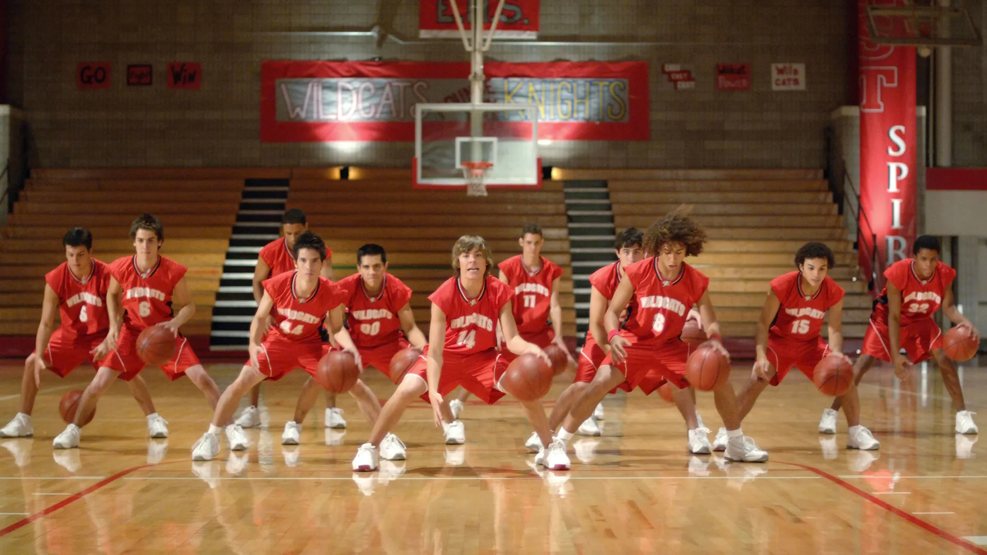 A group of Wildcats basketball players doing choreography with basketballs 