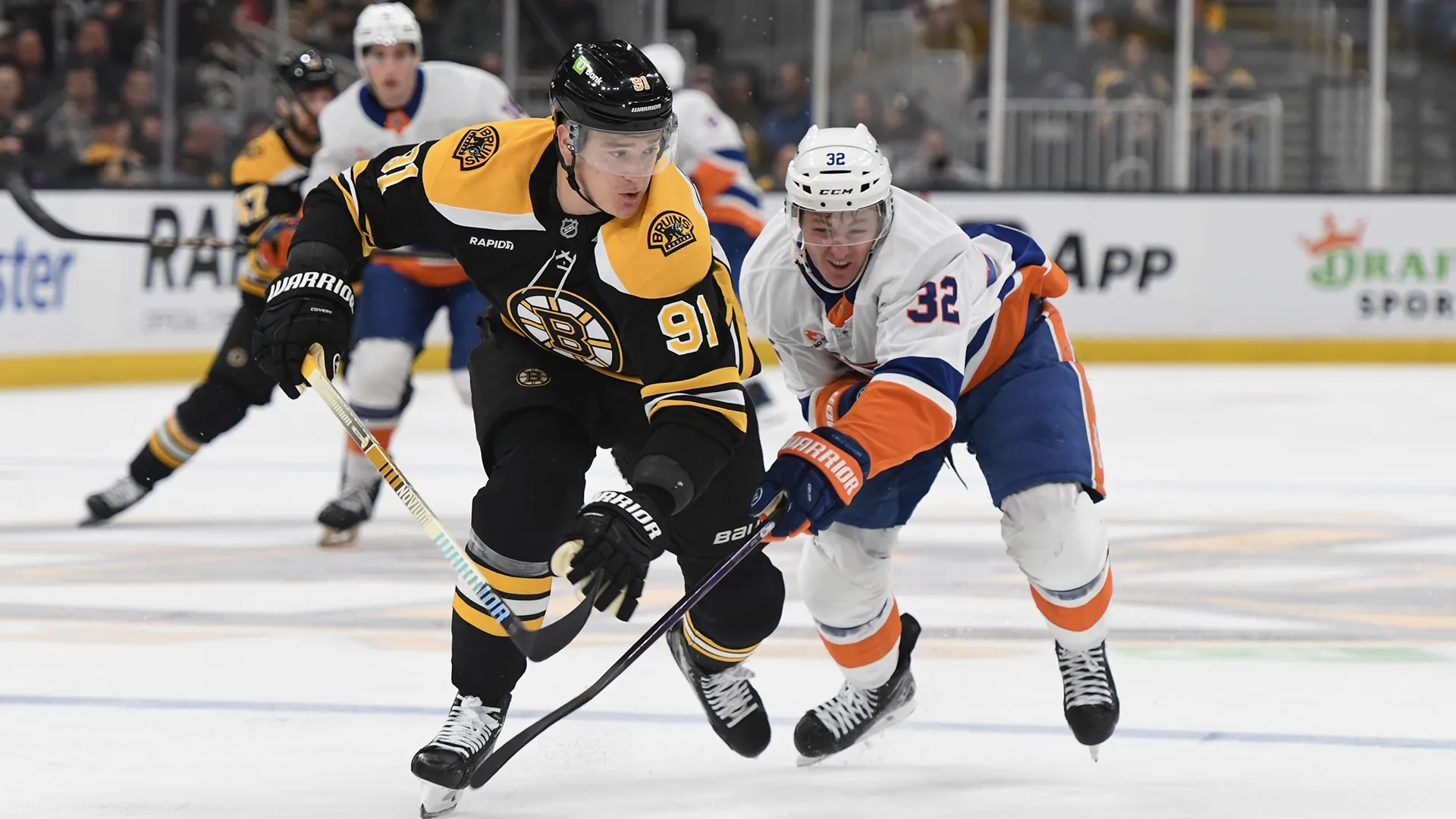 Nikita Zadorov of the Boston Bruins and Kyle MacLean of the New York Islanders during an NHL match.