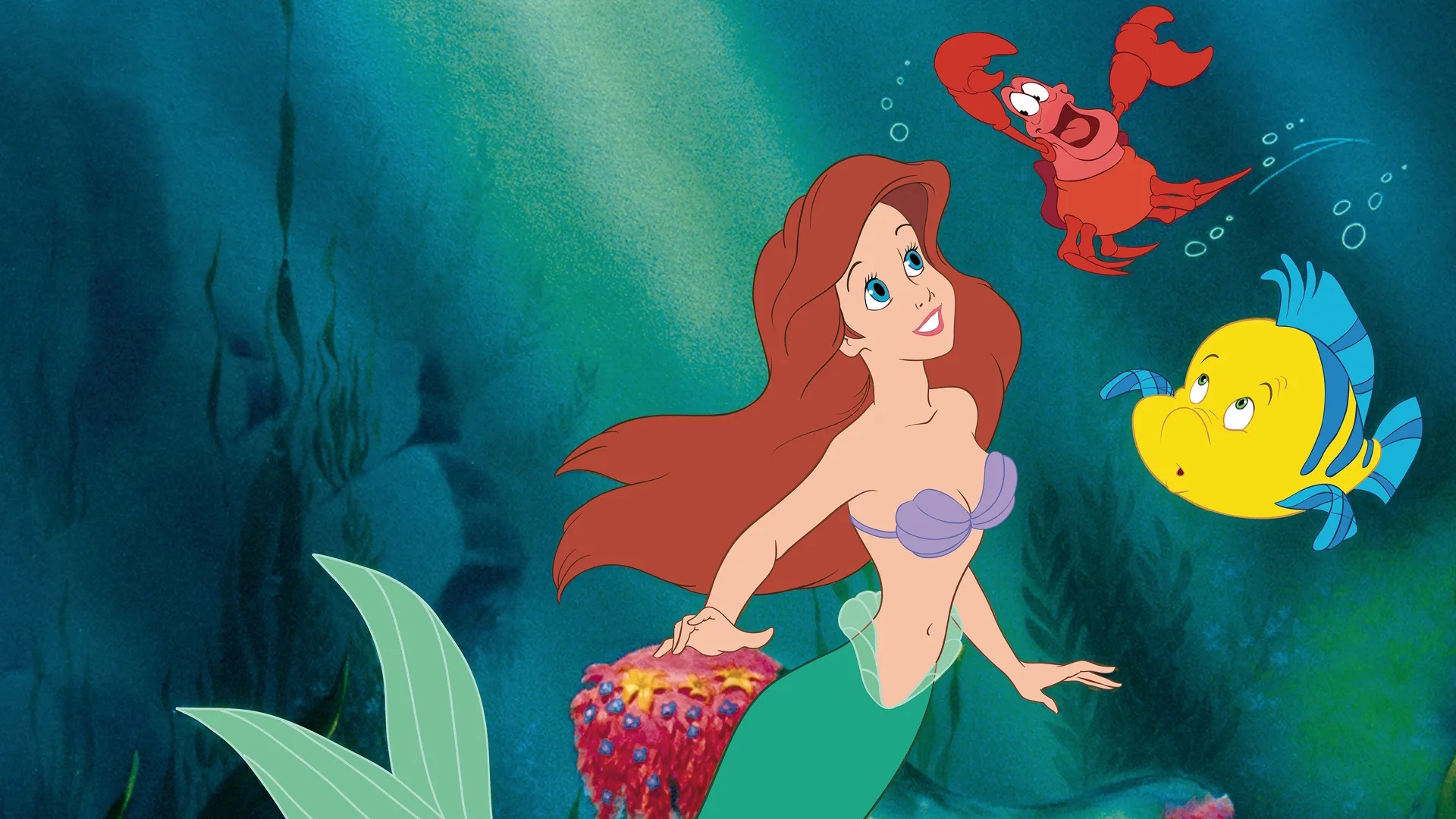 Ariel swims with Flounder and Sebastian in The Little Mermaid (1989)