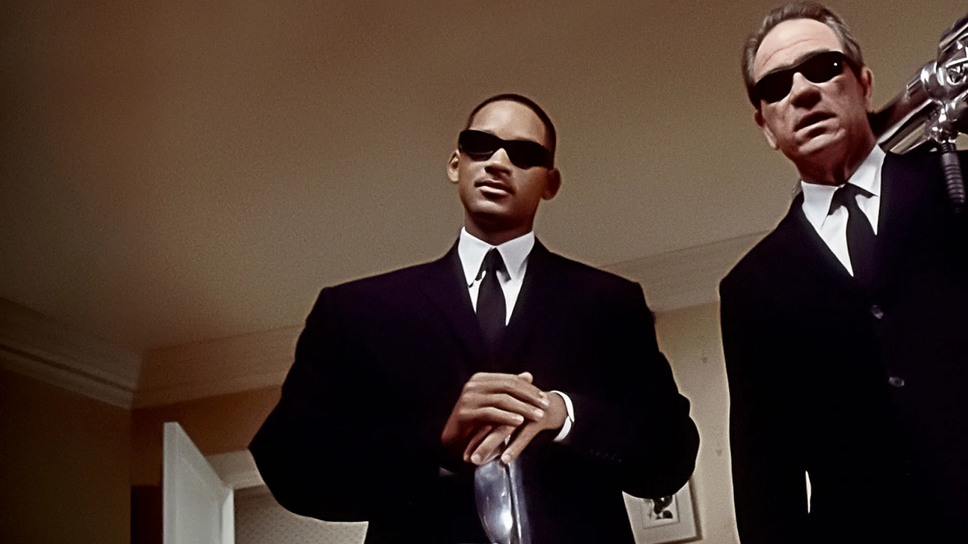 This image features characters from the Men in Black film franchise, starring Will Smith as Agent J and Tommy Lee Jones as Agent K.
