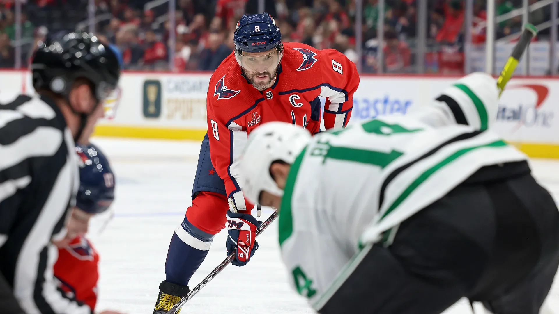 Alex Ovechkin of the Washington Capitals and a player from the Dallas Stars during an NHL match.