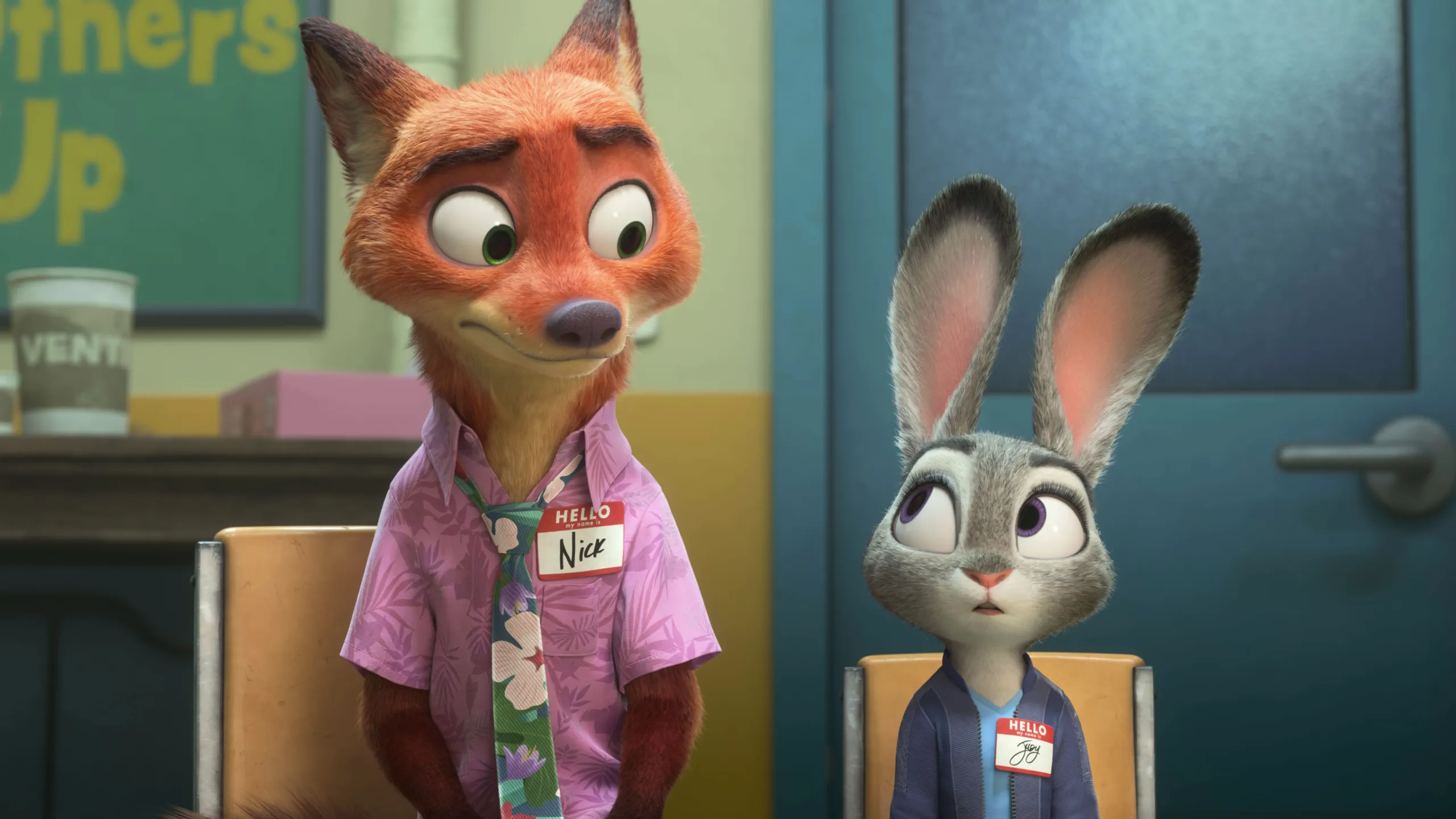 Nick Wilde (voiced by Jason Bateman) and Judy Hopps (voiced by Ginnifer Goodwin) sit in an office wearing name tags.